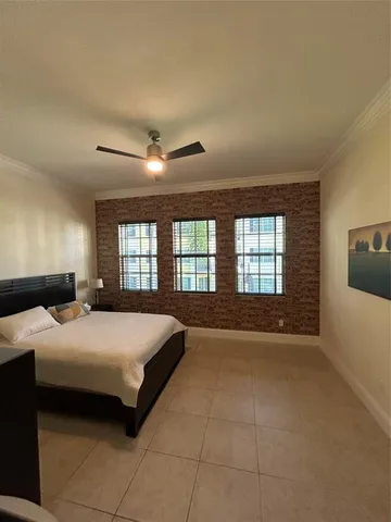 a large bedroom with a bed and a chandelier