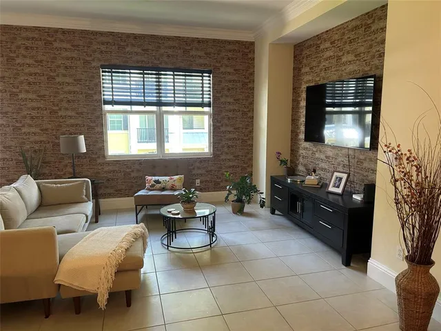 a living room with furniture a chandelier and a dining table