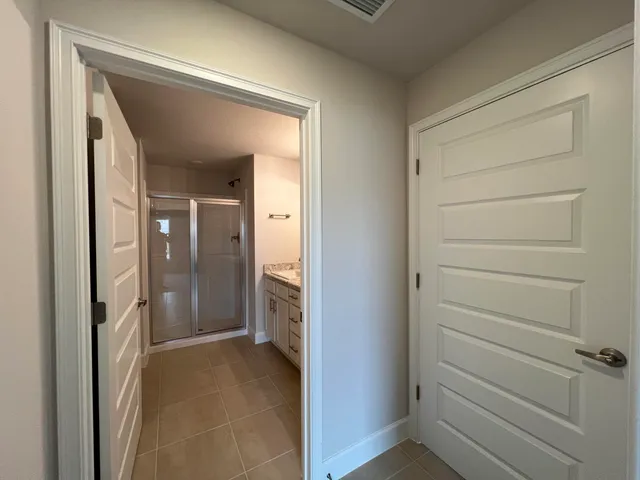 a view of a bathroom from a hallway