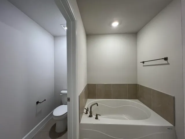 a bathroom with a bathtub and toilet