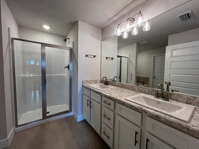a bathroom with a tub sink and mirror