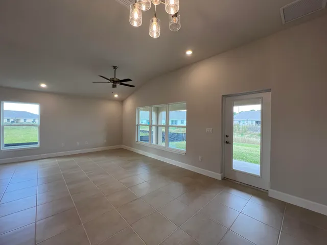 a kitchen with granite countertop white cabinets stainless steel appliances and a sink