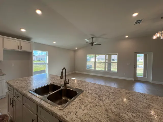 a view of house with backyard