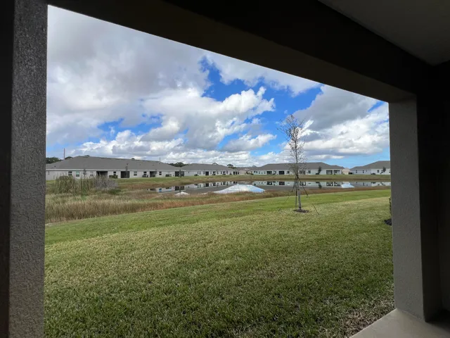 a view of a garden with wooden fence