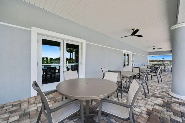 a view of a backyard with table and chairs under an umbrella