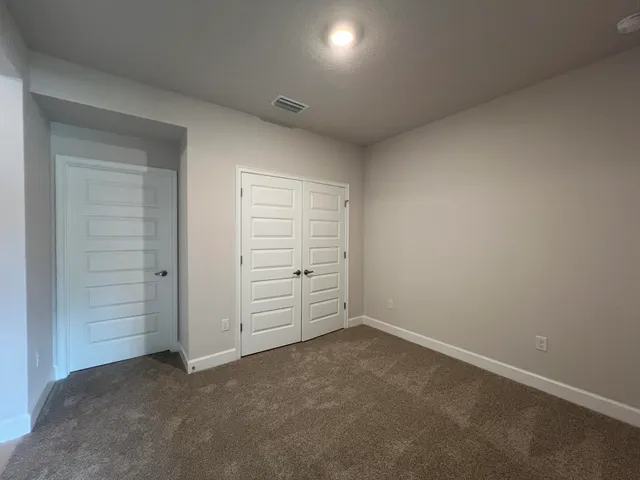 an empty room with closet area
