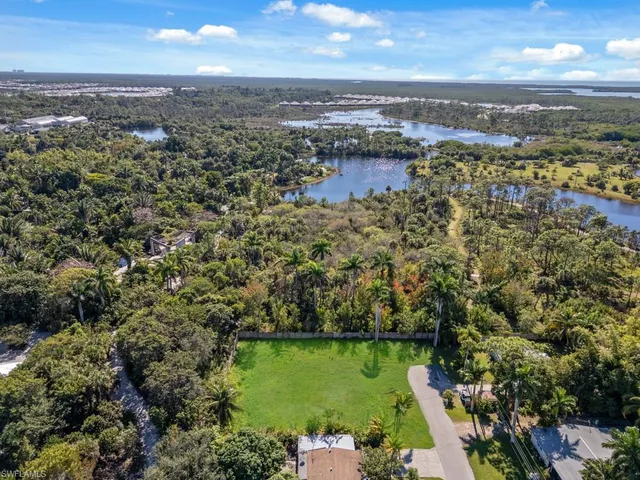 an aerial view of a houses with a lake view