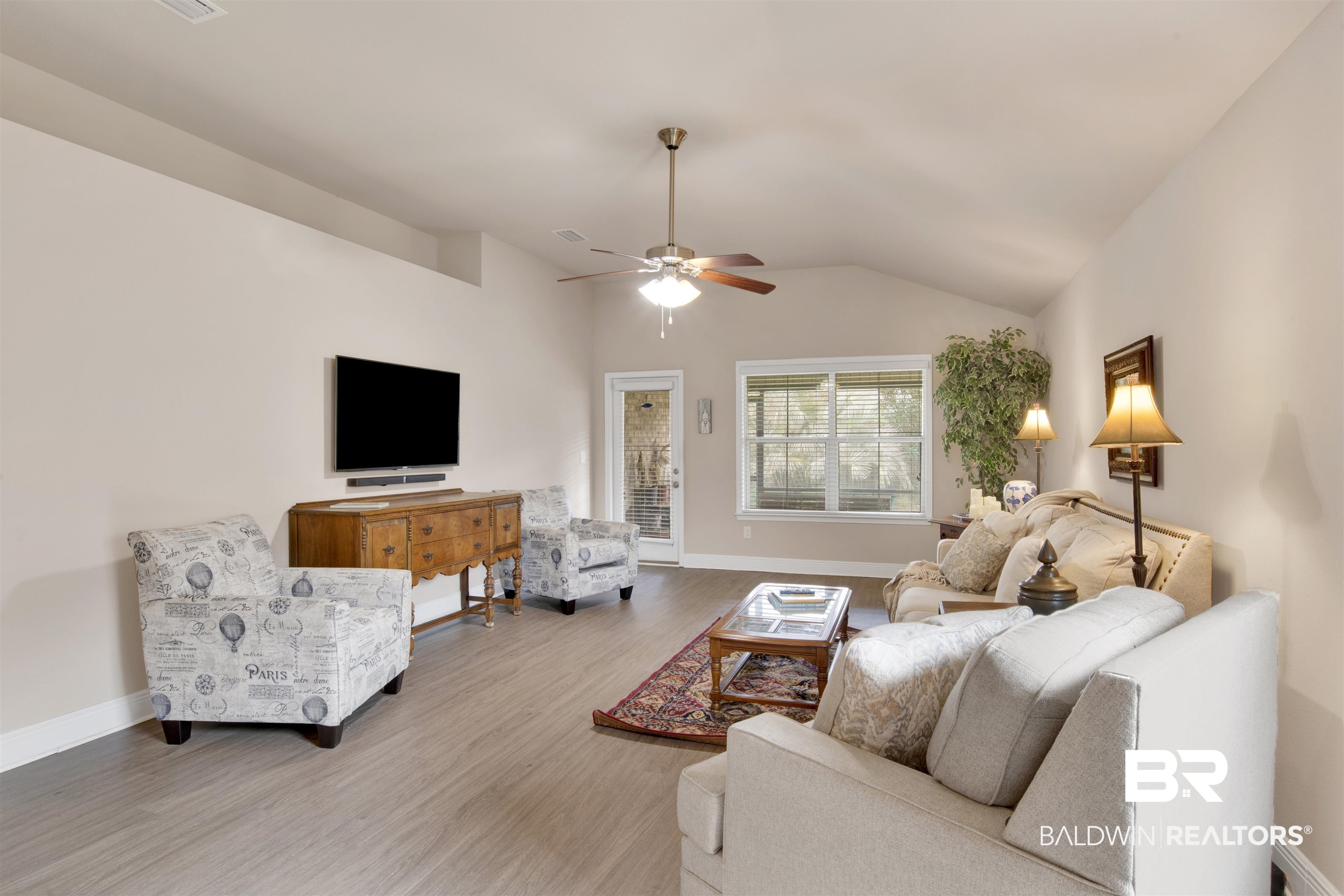 22056 Garland Loop Silverhill, AL 36576 - Photo 12 of 28 Living room with a ceiling fan, baseboards, vaulted ceiling, and wood finished floors