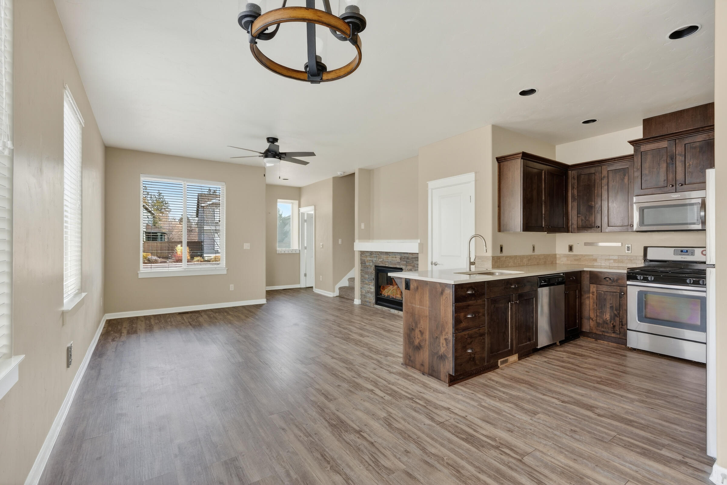 3365 Southwest 28th Street Redmond, OR 97756 - Photo 10 of 39 a large kitchen with stainless steel appliances granite countertop a stove and a wooden floors