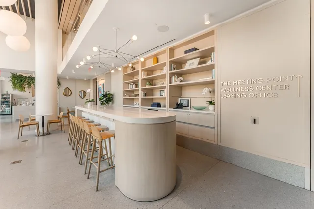 a kitchen with a sink and chairs