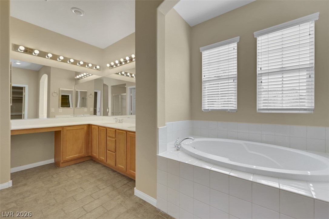 10328 Hawk Ravine Street Las Vegas, NV 89178 - Photo 41 of 55 Relax in the oversized soaking tub in this generously proportioned primary bathroom.