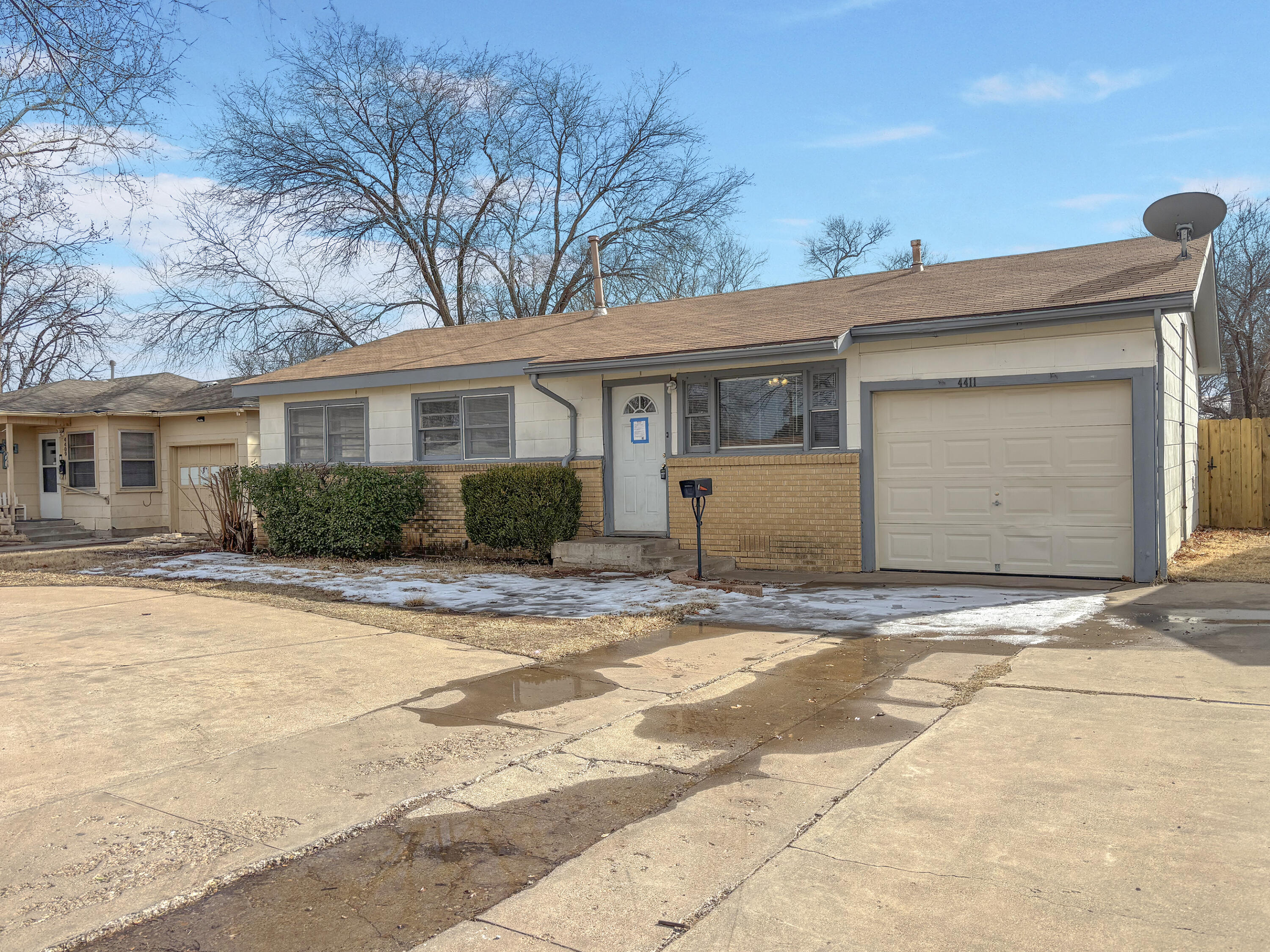 4411 45th Street Lubbock, TX 79414 - Photo 1 of 44 a front view of a house with a yard and garage