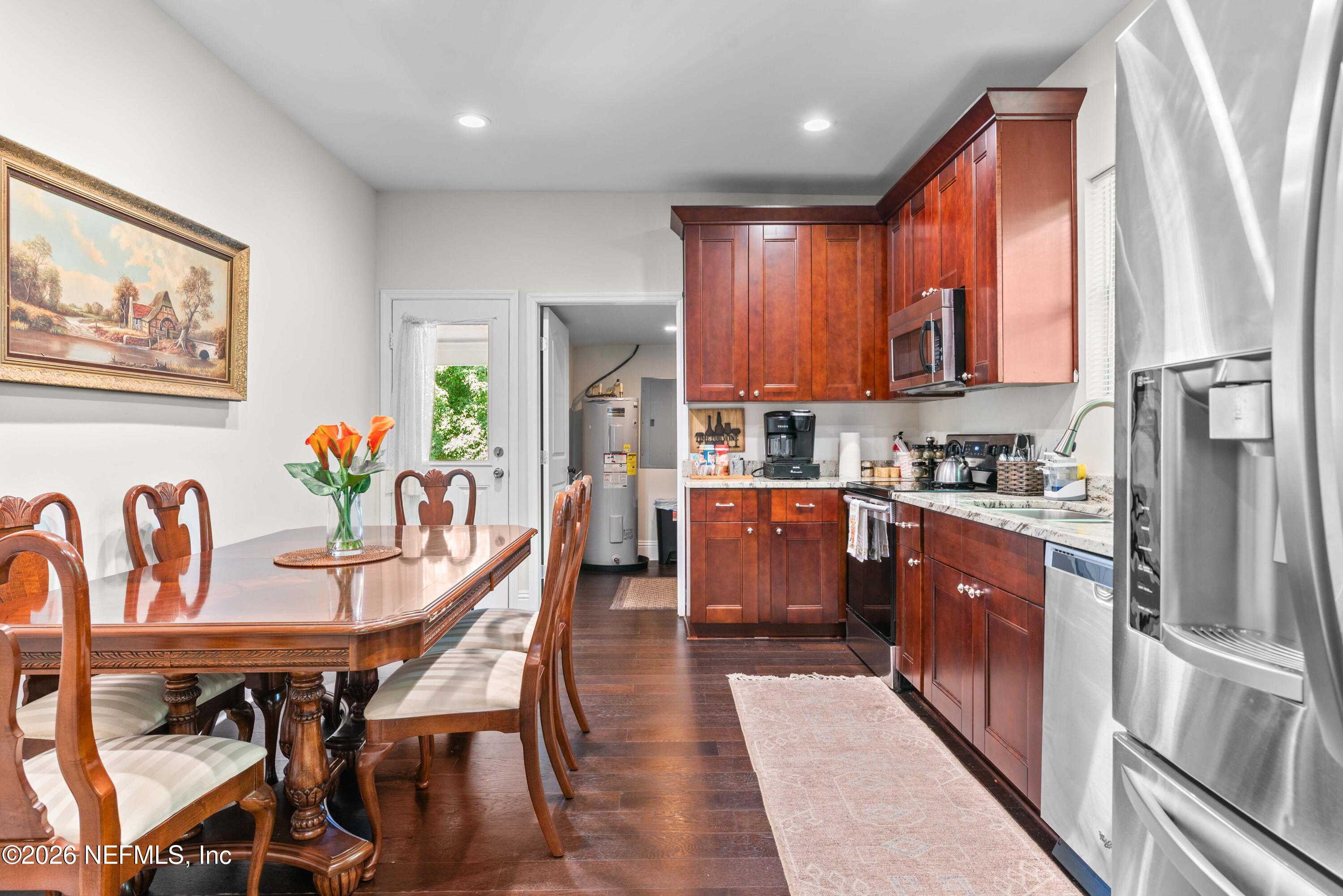 1138 Walnut Street Jacksonville, FL 32206 - Photo 23 of 37 a kitchen with stainless steel appliances granite countertop a stove a refrigerator a kitchen island a table and chairs