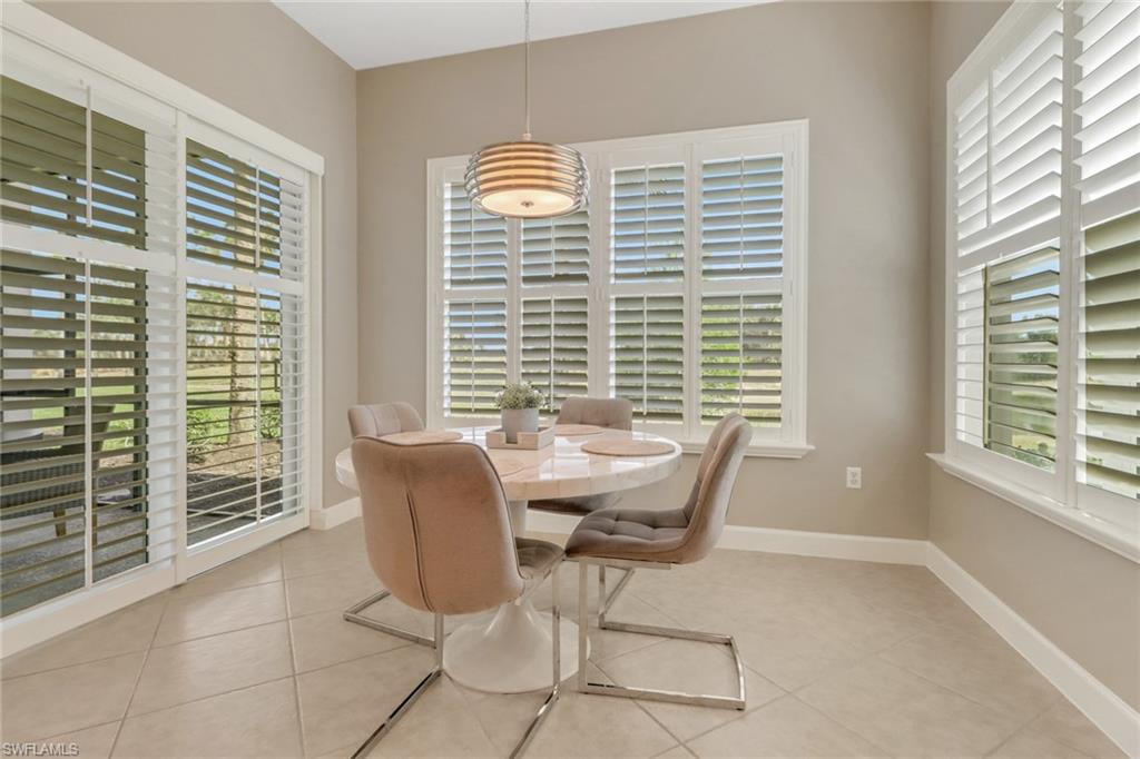 9208 Quartz Lane, Unit 102 Naples, FL 34120 - Photo 11 of 31 a dining room with furniture and windows