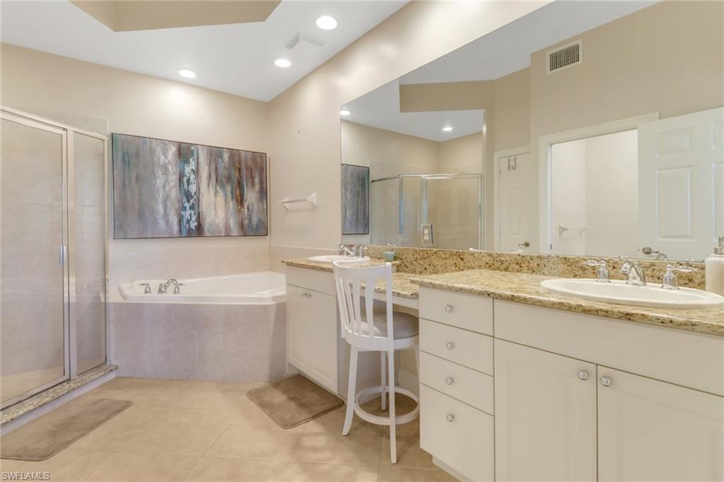 9208 Quartz Lane, Unit 102 Naples, FL 34120 - Photo 14 of 31 a bathroom with a granite countertop sink and a mirror
