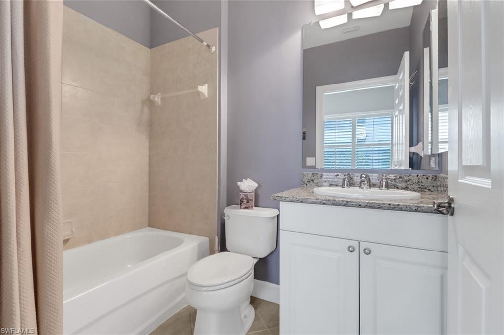 9208 Quartz Lane, Unit 102 Naples, FL 34120 - Photo 18 of 31 a bathroom with a granite countertop sink a toilet and shower