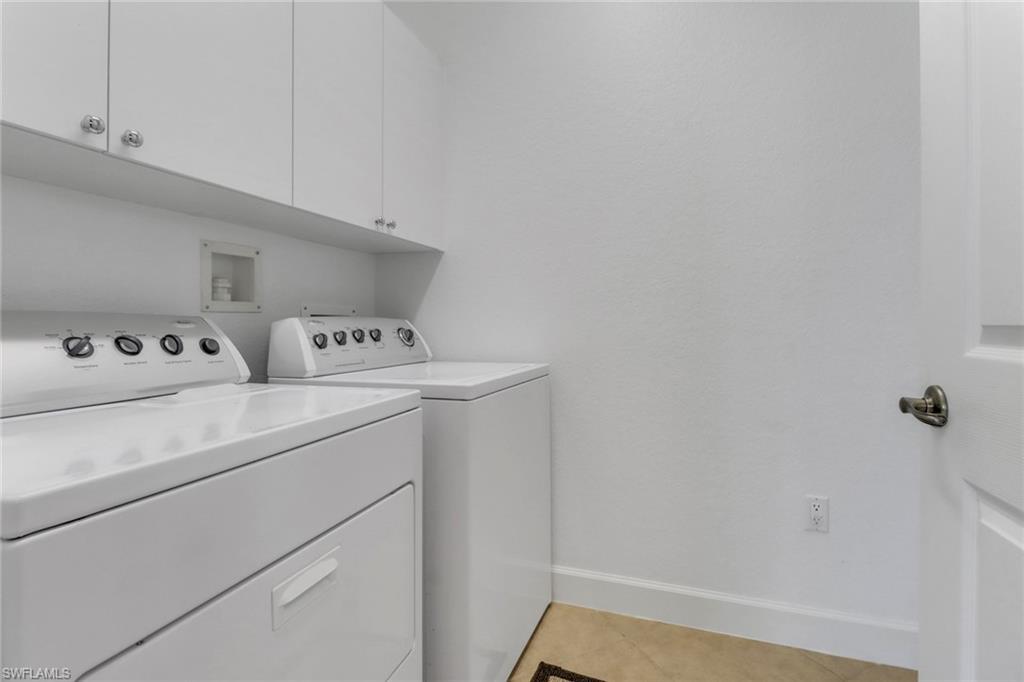 9208 Quartz Lane, Unit 102 Naples, FL 34120 - Photo 21 of 31 a utility room with dryer and washer