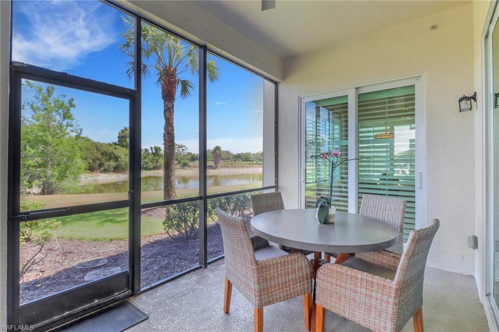 9208 Quartz Lane, Unit 102 Naples, FL 34120 - Photo 22 of 31 a dining room with furniture window and wooden floor