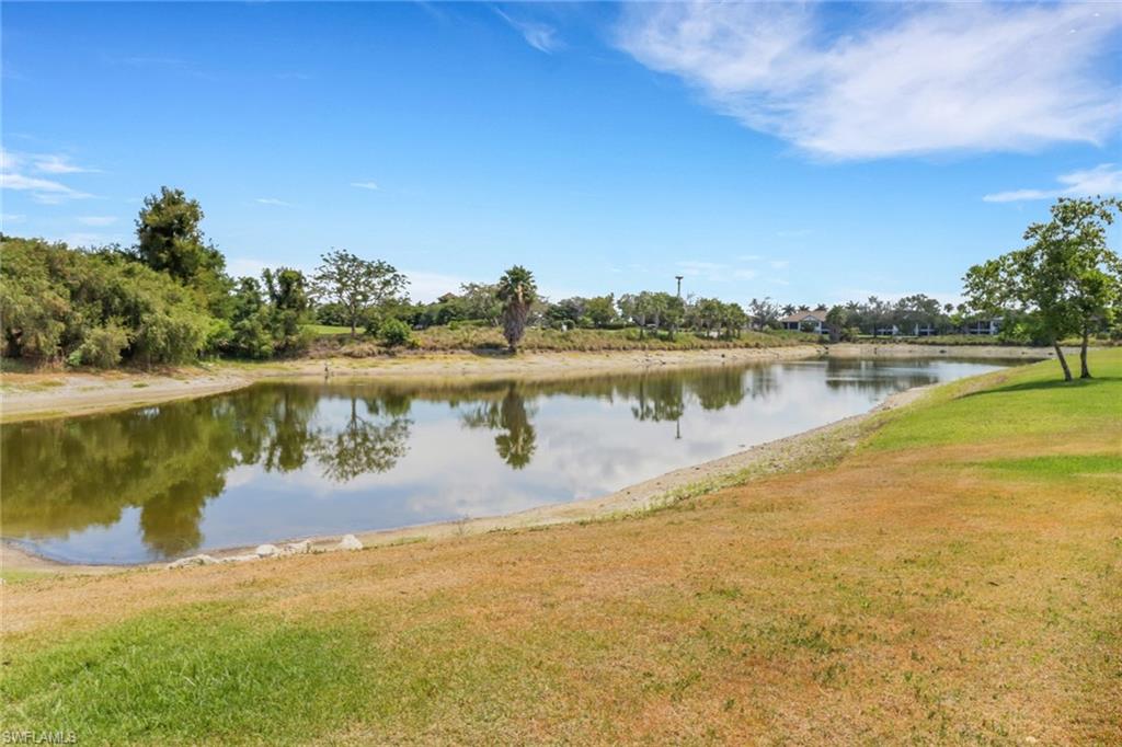 9208 Quartz Lane, Unit 102 Naples, FL 34120 - Photo 25 of 31 a view of a lake with houses in the back