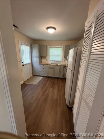 a room with a washer dryer and a flat screen tv