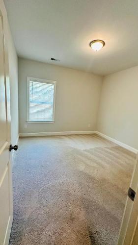232 Chateau Way Angier, NC 27501 - Photo 14 of 23 an empty room with a empty space and windows