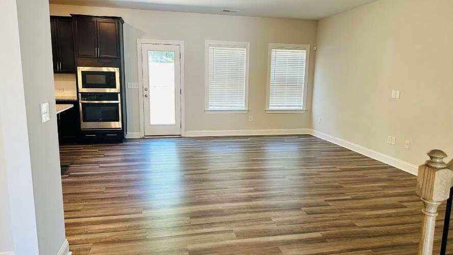 232 Chateau Way Angier, NC 27501 - Photo 16 of 23 a view of an empty room with a window and wooden floor