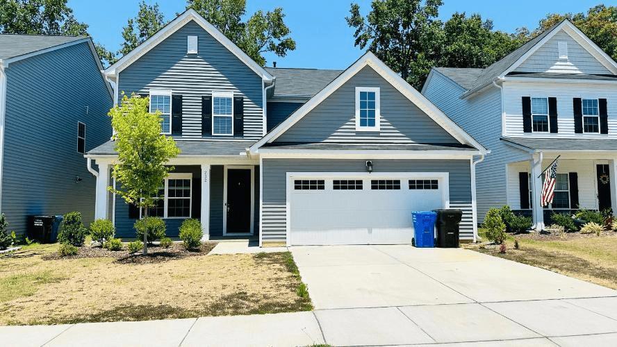 232 Chateau Way Angier, NC 27501 - Photo 2 of 23 a front view of a house with garden