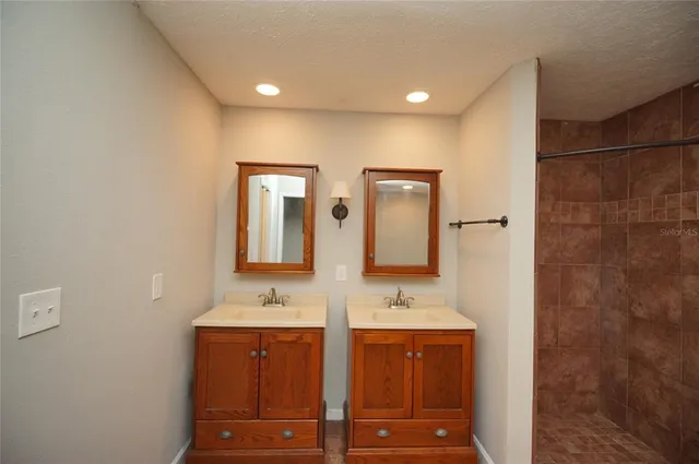 an empty room with wooden floor chandelier fan and closet area