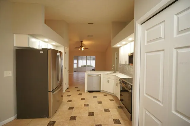 a kitchen with a sink stove and refrigerator