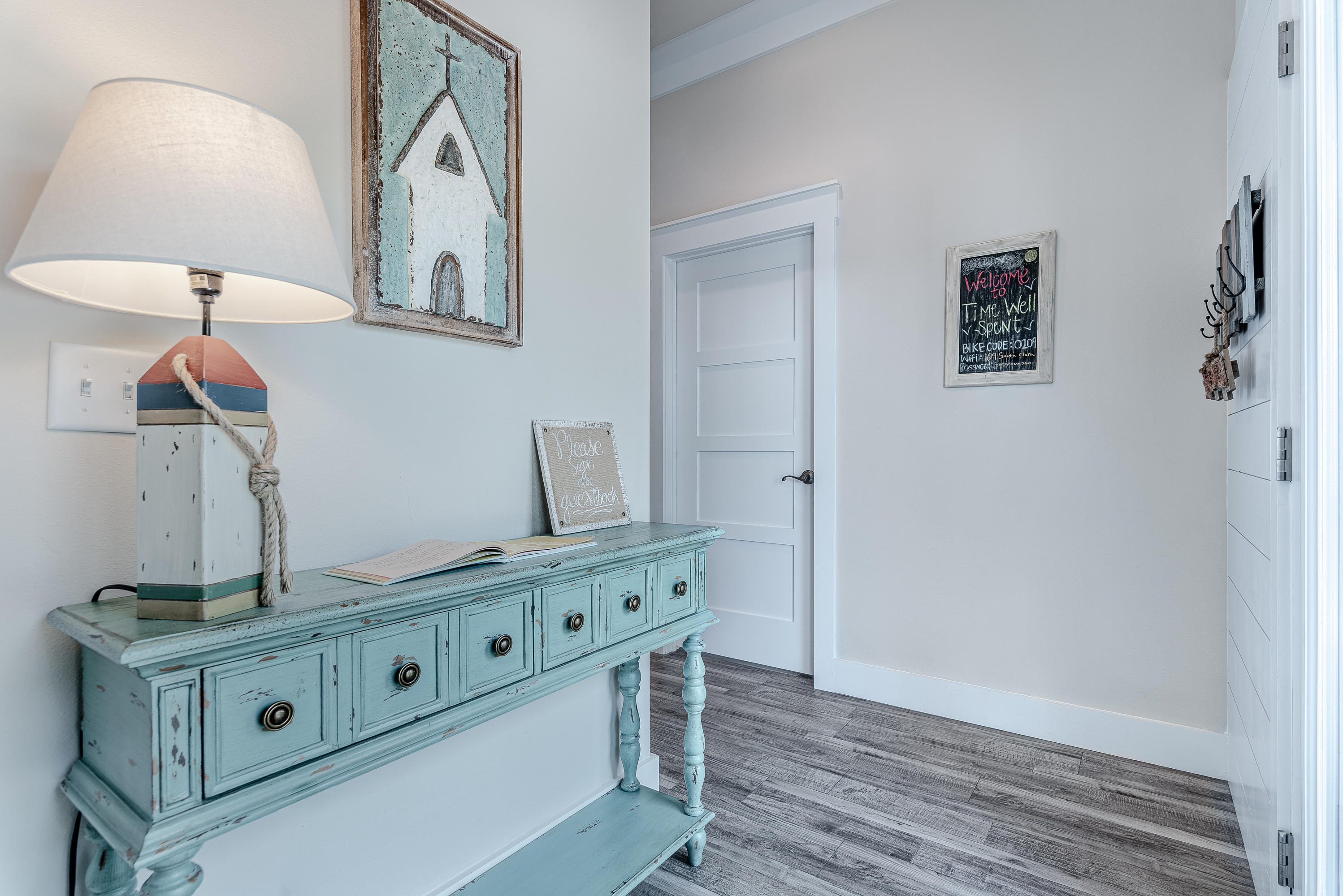 109 Santa Clara Street Santa Rosa Beach, FL 32459 - Photo 11 of 41 a room with kitchen island a stove a sink and a wooden floor