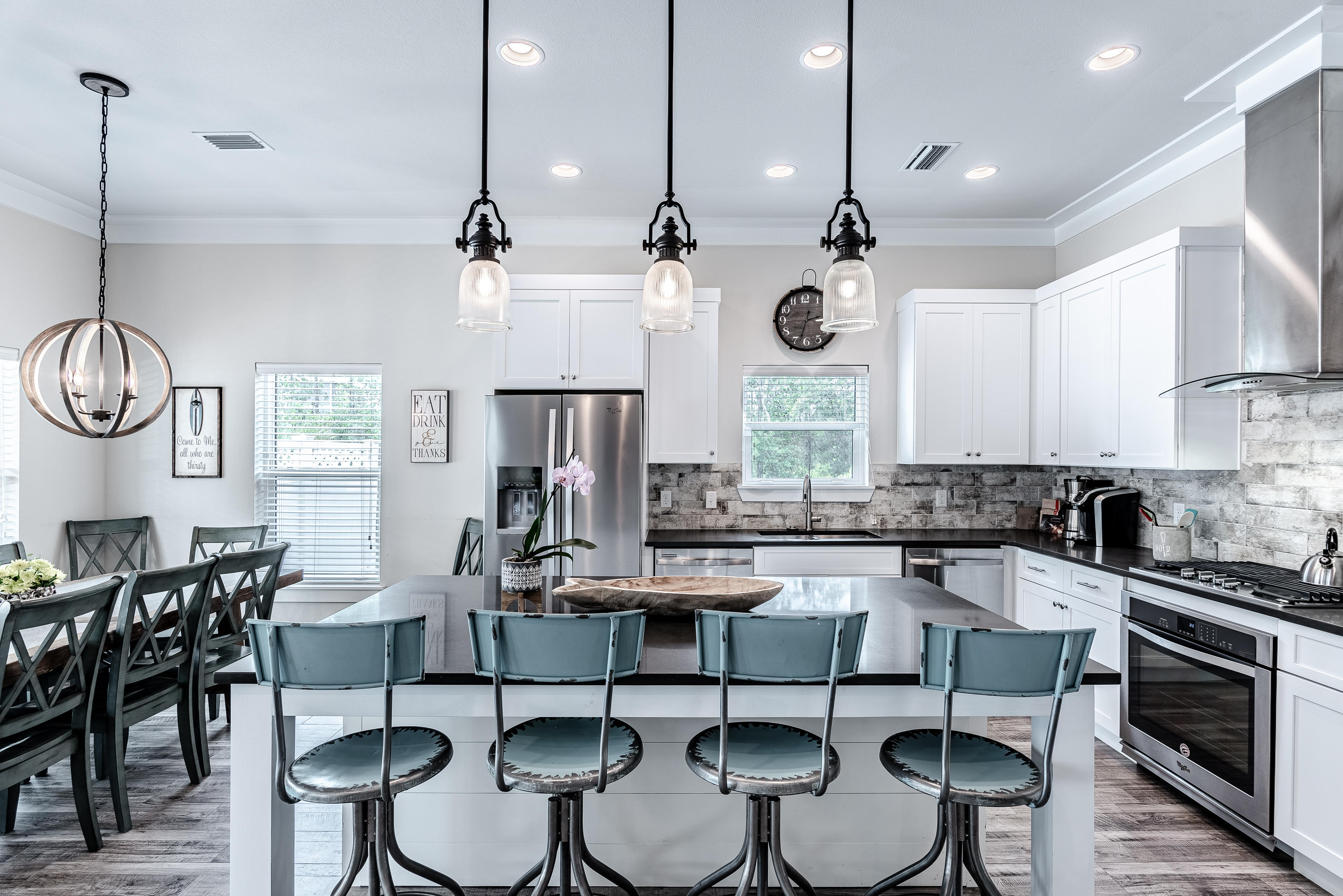 109 Santa Clara Street Santa Rosa Beach, FL 32459 - Photo 6 of 41 a kitchen with stainless steel appliances a dining table chairs and white cabinets