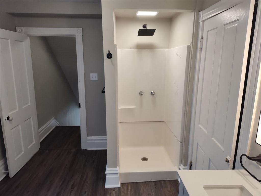 533 3rd Street Pitcairn, PA 15140 - Photo 20 of 37 a bathroom with a sink and glass door with wooden floor