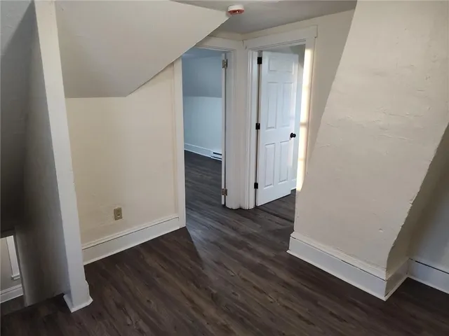 an empty room with wooden floor