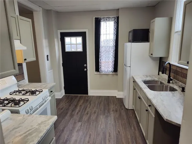 a kitchen with a sink and a refrigerator