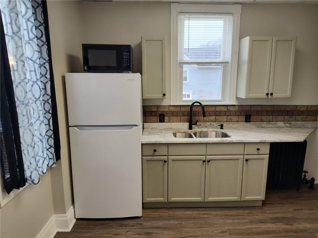 533 3rd Street Pitcairn, PA 15140 - Photo 8 of 37 a kitchen with a sink and a refrigerator