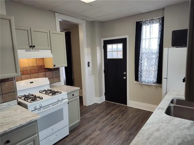 a kitchen with a stove and a sink