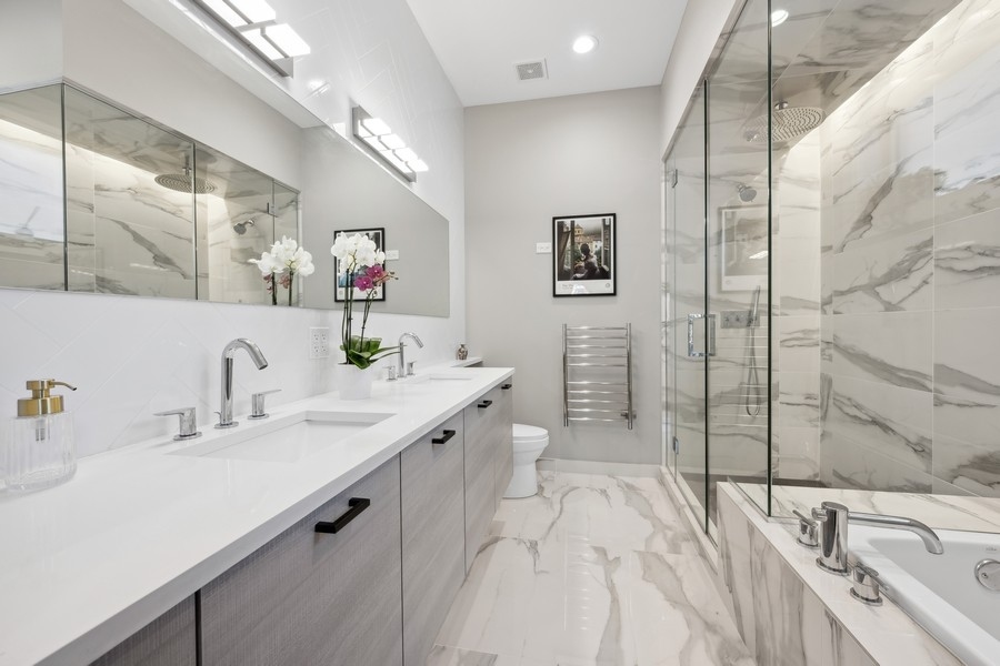 2046 West Rice Street, Unit 2 Chicago, IL 60622 - Photo 10 of 14 a spacious bathroom with a tub sink and mirror