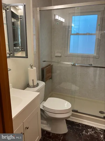a bathroom with a toilet a sink and a mirror