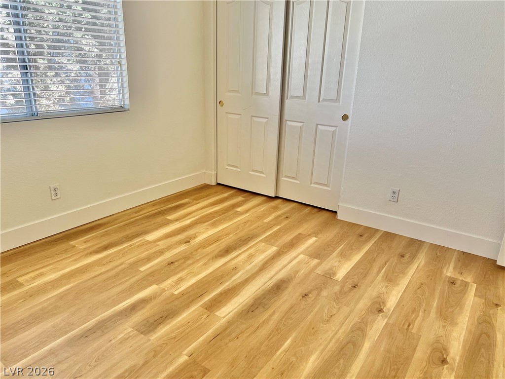 9708 Ridge Creek Place Las Vegas, NV 89134 - Photo 19 of 34 2nd Bedroom. Luxury vinyl plank flooring complements the bright, inviting walls, creating a versatile blank canvas.