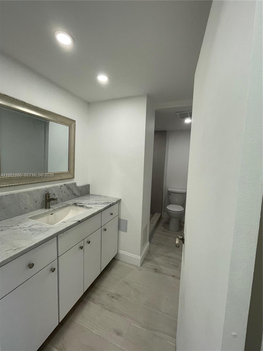 2160 Southwest 16th Avenue, Unit 115 Miami, FL 33145 - Photo 14 of 31 a bathroom with a granite countertop sink mirror and vanity