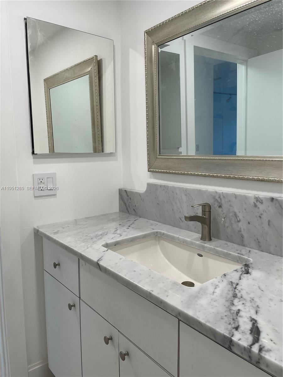 2160 Southwest 16th Avenue, Unit 115 Miami, FL 33145 - Photo 15 of 31 a bathroom with a sink and a mirror