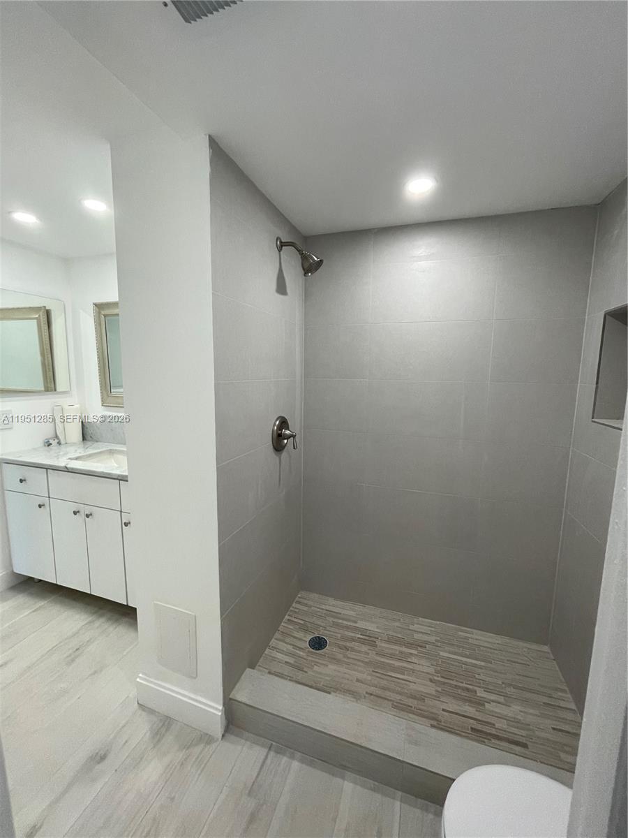 2160 Southwest 16th Avenue, Unit 115 Miami, FL 33145 - Photo 17 of 31 a bathroom with a sink a toilet and shower
