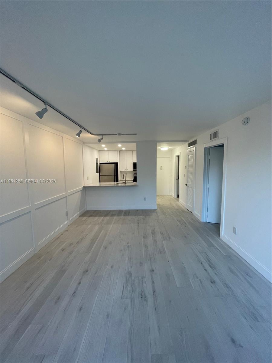 2160 Southwest 16th Avenue, Unit 115 Miami, FL 33145 - Photo 5 of 31 a view of a livingroom with wooden floor