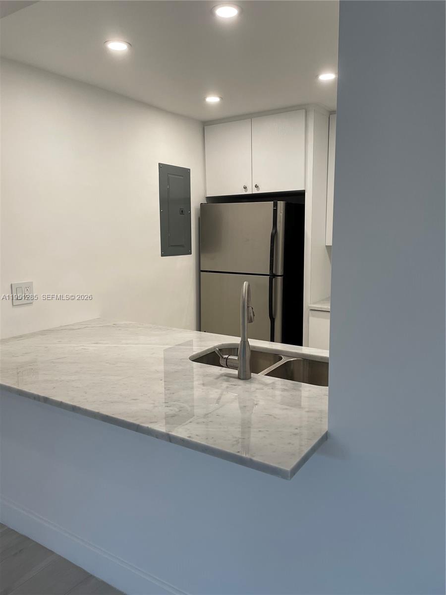 2160 Southwest 16th Avenue, Unit 115 Miami, FL 33145 - Photo 6 of 31 a view of kitchen with stainless steel appliances granite countertop a refrigerator a sink and a stove