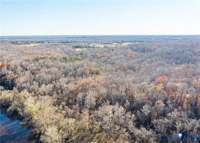 an aerial view of house with yard and mountain view in back