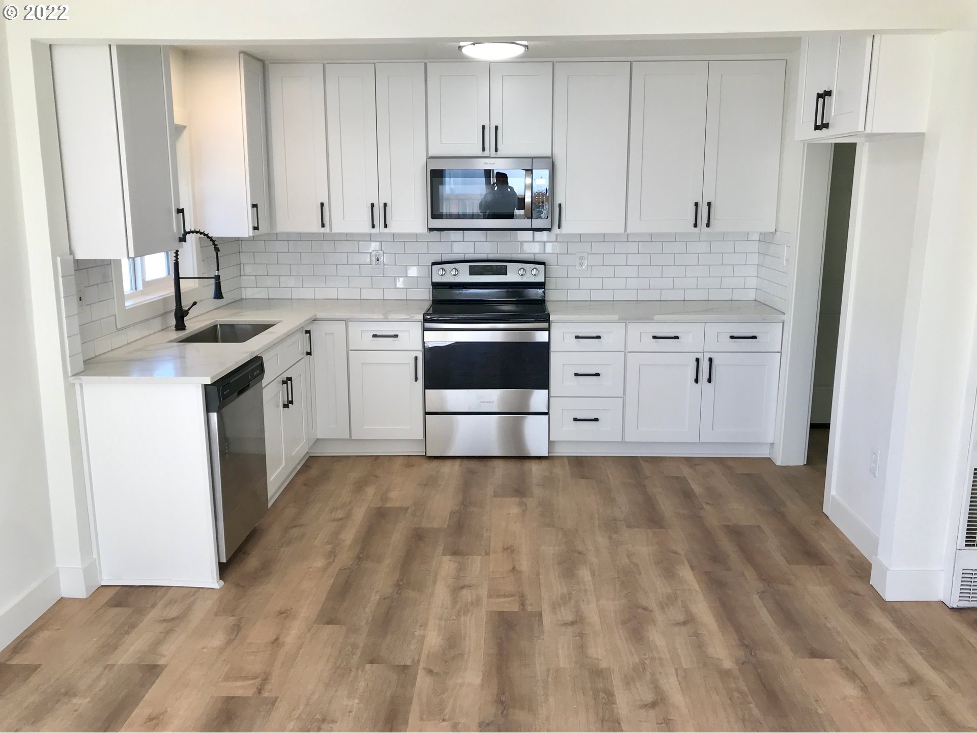 1141 1st Street Springfield, OR 97477 - Photo 3 of 13 a kitchen with granite countertop white cabinets and stainless steel appliances