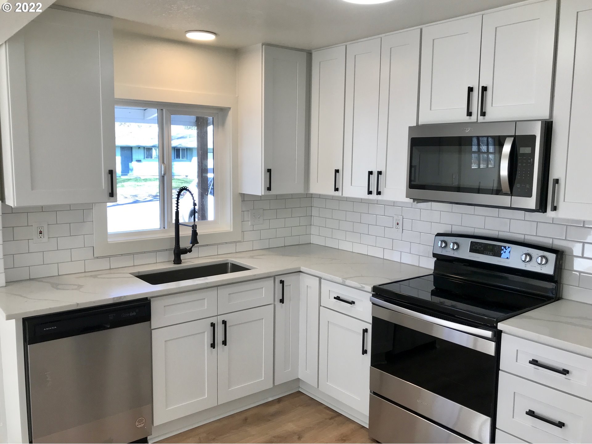 1141 1st Street Springfield, OR 97477 - Photo 4 of 13 a kitchen with cabinets stainless steel appliances and a sink