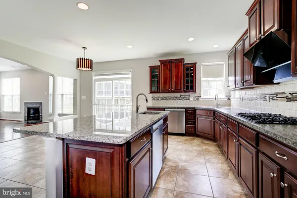 a kitchen with stainless steel appliances granite countertop a stove sink and cabinets