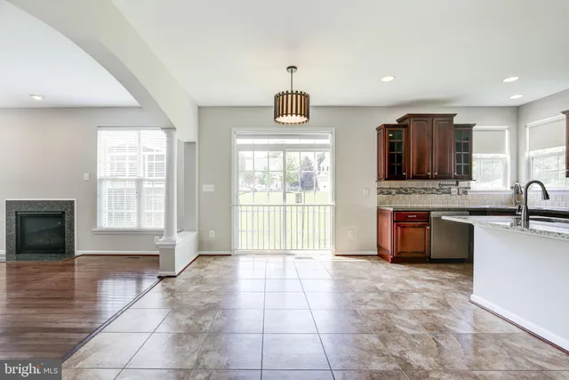 a view of kitchen with granite countertop a stove top oven a sink a counter space and cabinets