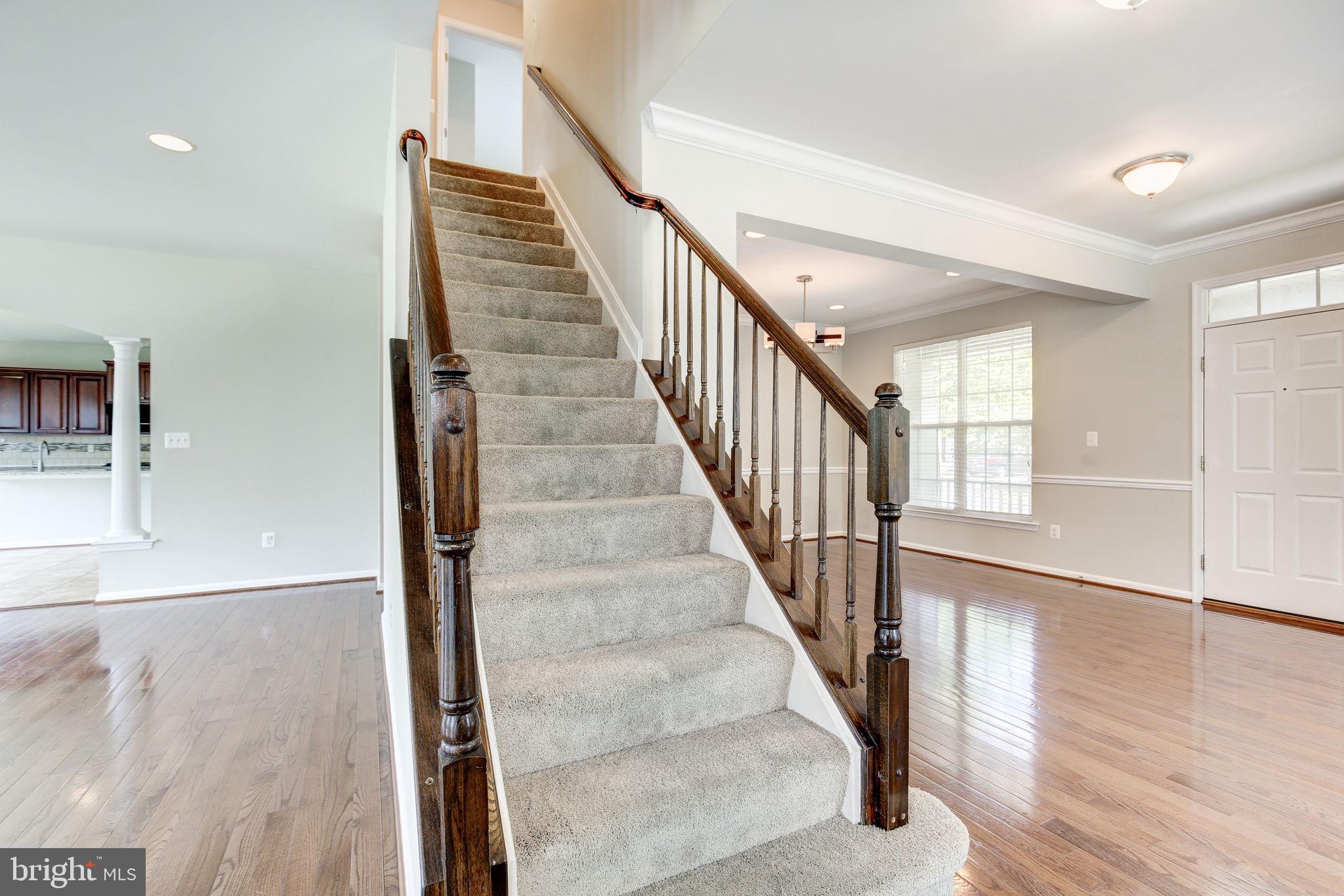 2311 Whitley Road Baltimore, MD 21209 - Photo 21 of 47 a view of staircase with lots of frames on wall and wooden floor